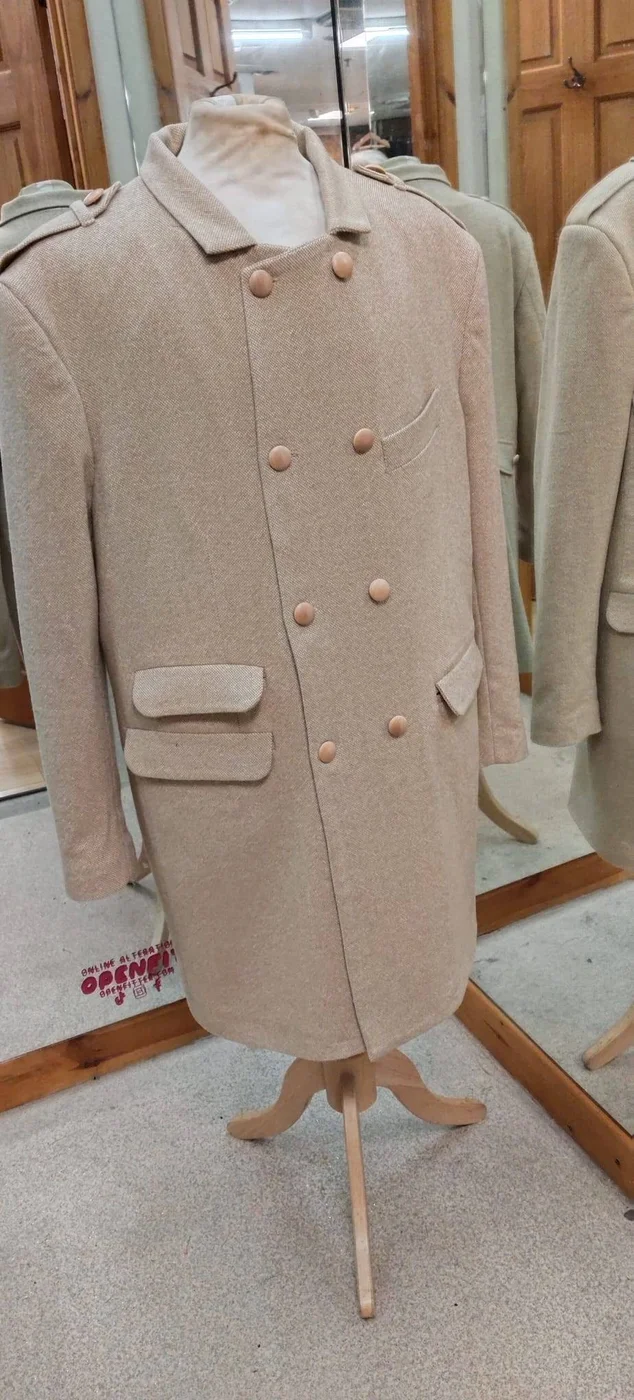 Cream overcoat on a dressform at Openfit