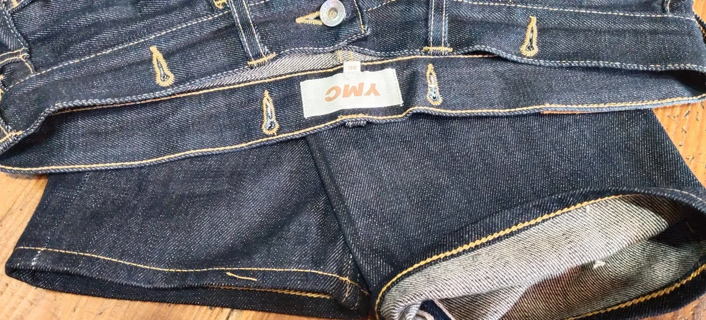 Dark denim jeans showing the fly and waistband area