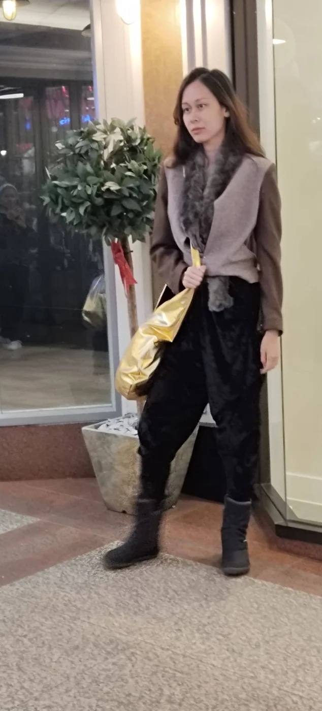 Model wearing tailored shearling jacket outside Flying Horse Walk