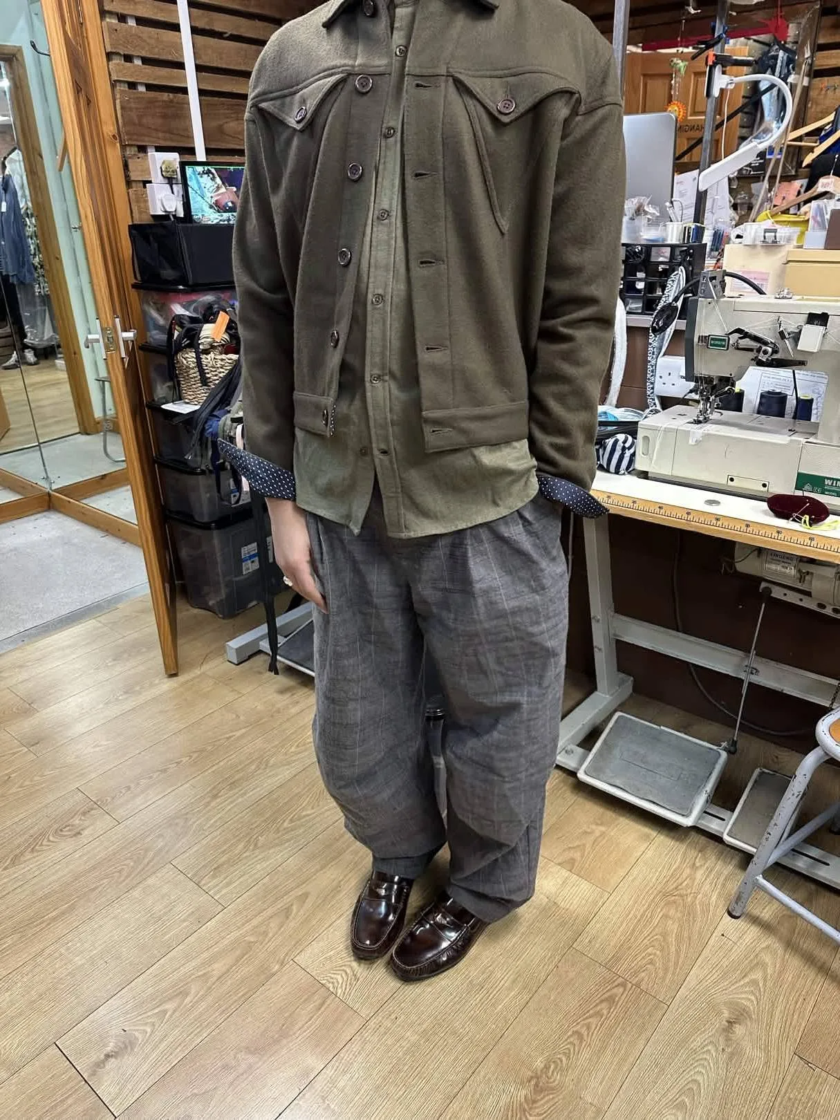 Customer wearing a jacket and checked trousers during an Openfit fitting