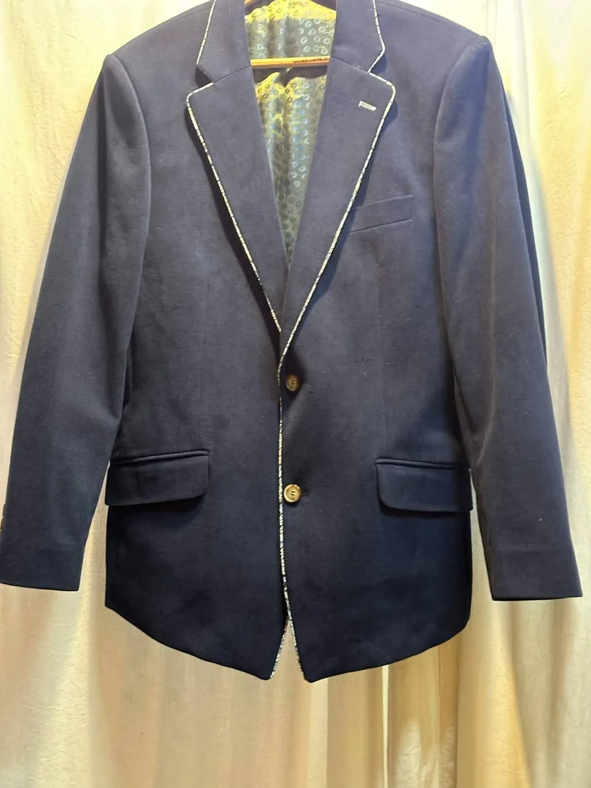 Navy single-button blazer with contrast piping on the lapels and front edges